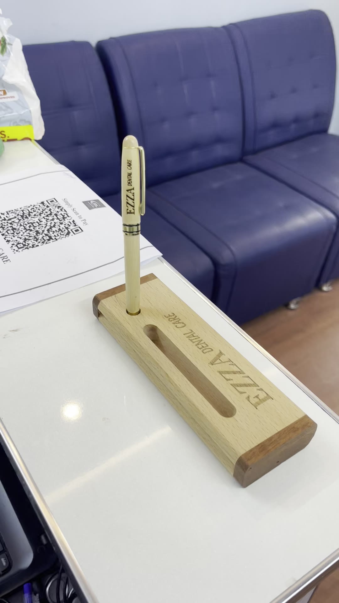 Branded Ezza name plate at the Ezza Dental Care reception desk